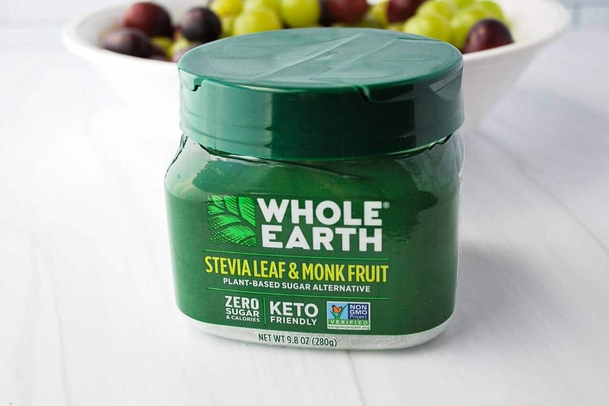jar of whole earth sweetener with grapes in the background