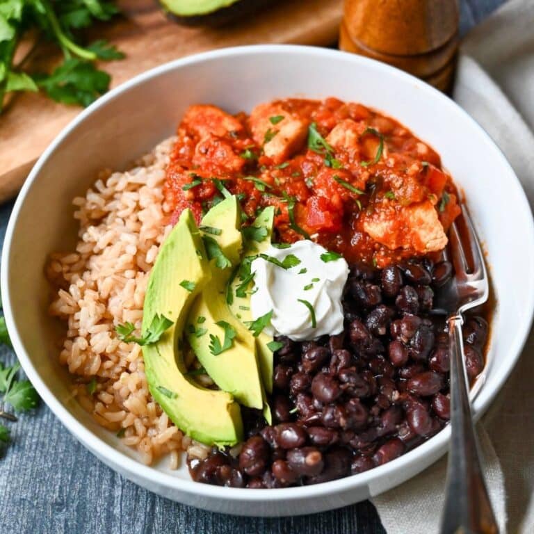 a salsa chicken burrito bowl with a fork