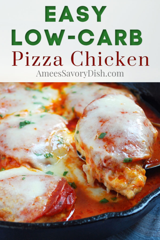 Chicken breasts covered in sauce and cheese in a skillet with a spoon lifting up one piece of chicken 