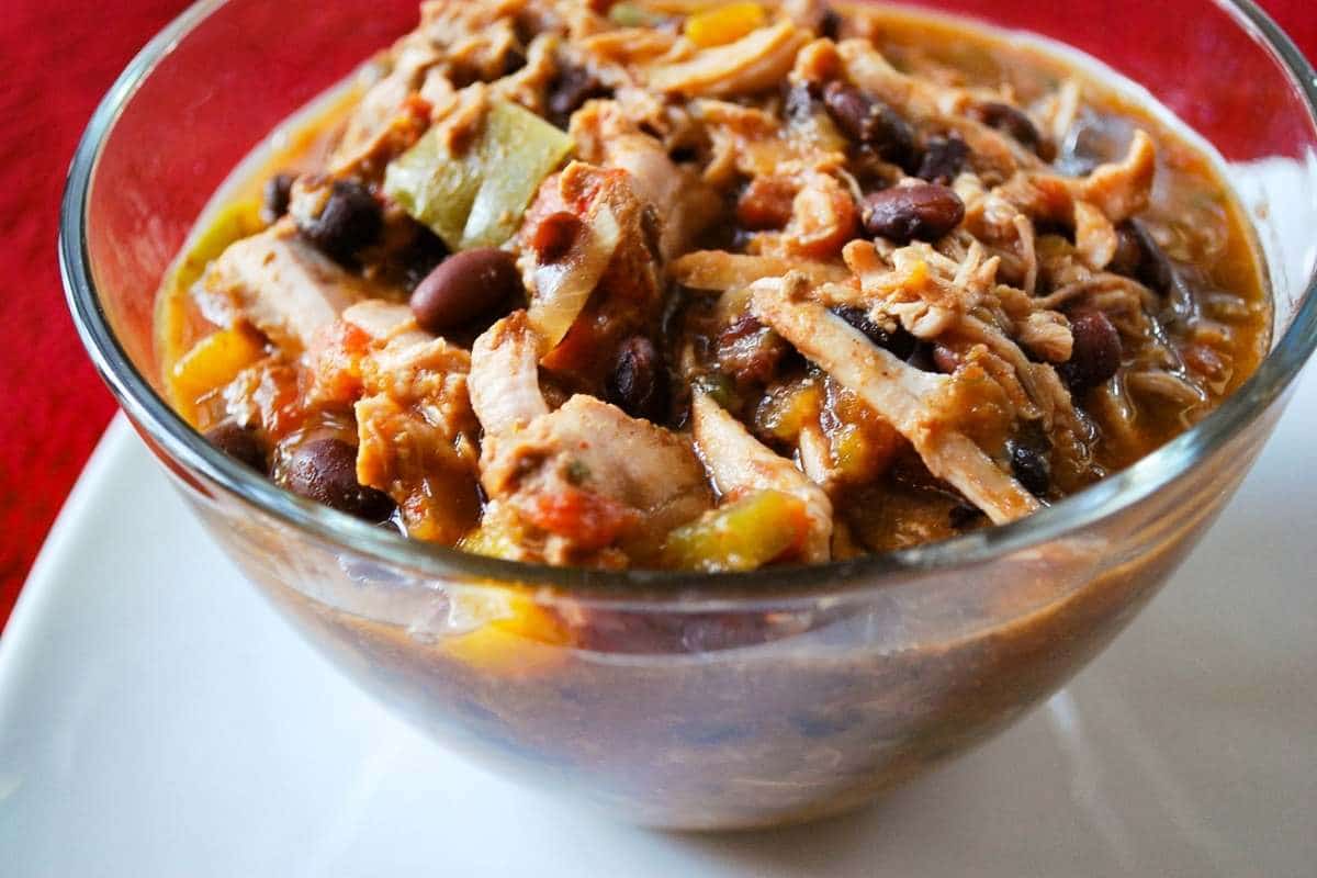 Bowl of pork tenderloin chili on a white plate