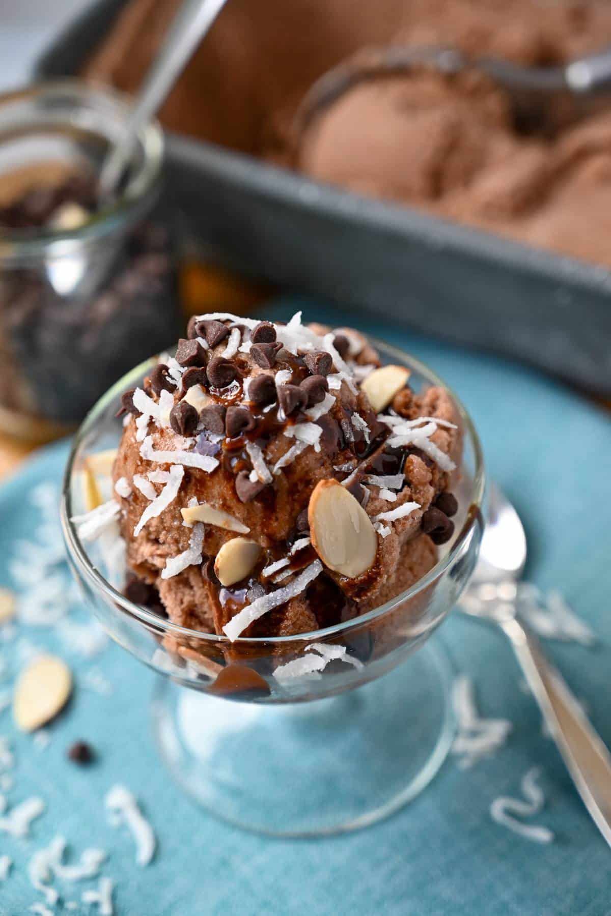 a parfait dish of chocolate vegan ice cream with almond joy inspired toppings