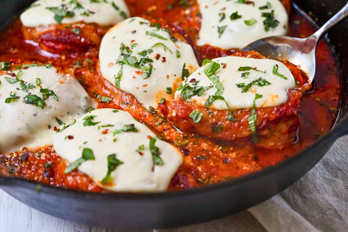 holding up a spoonful of pizza chicken just baked