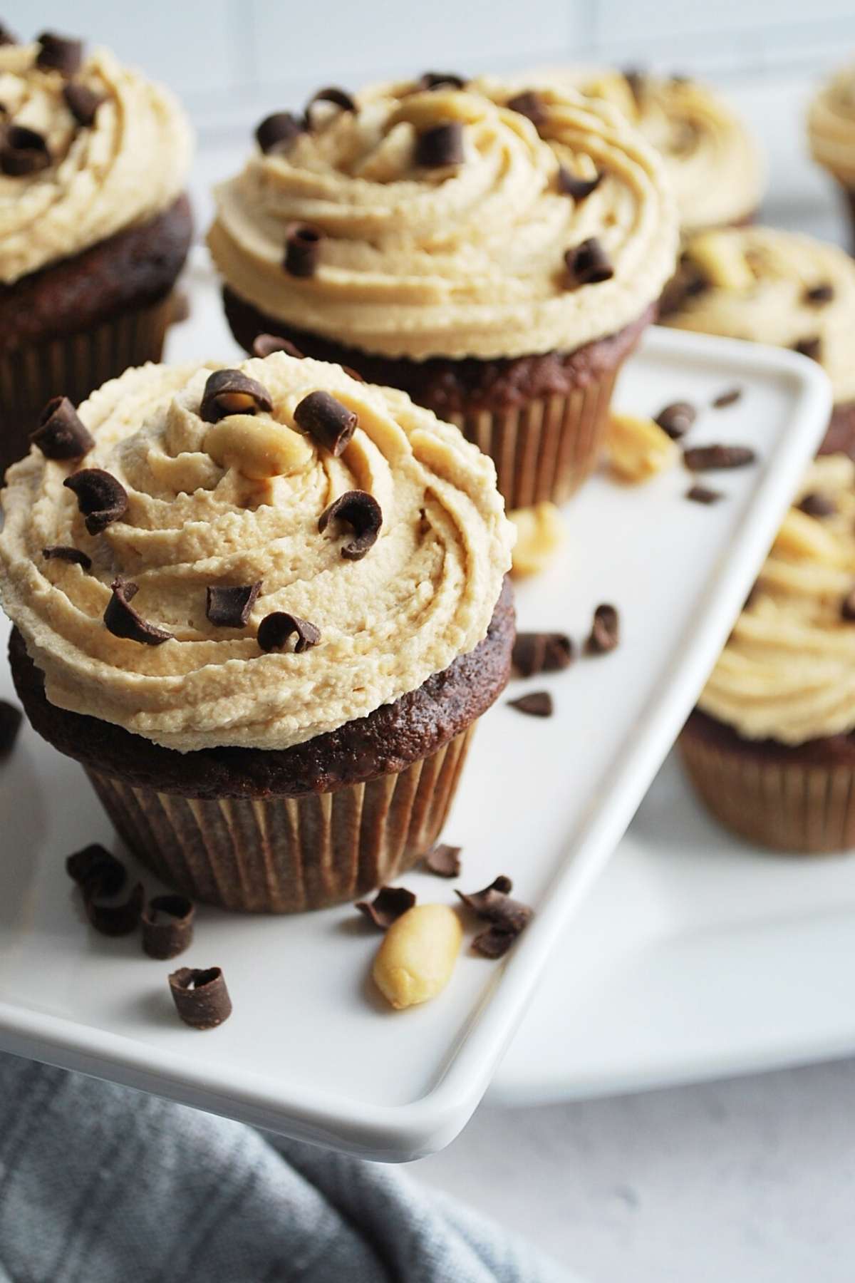 platter of frosted cupcakes with a napkin underneath