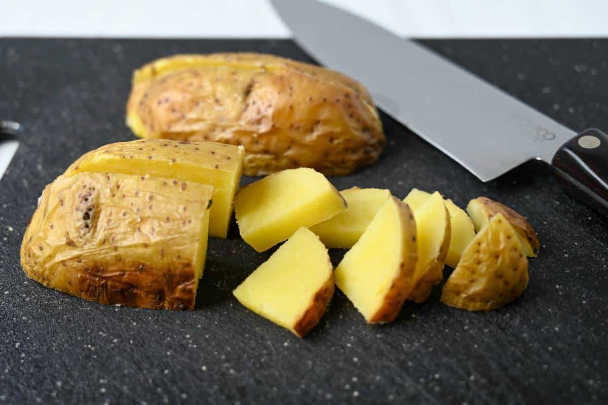 sliced yukon gold potatoes on a cutting board