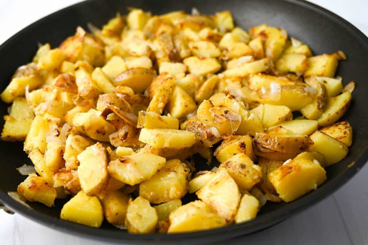 potatoes and onions cooked in a skillet