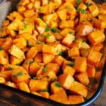 zoomed in photo of a pan of garlic and rosemary roasted sweet potatoes