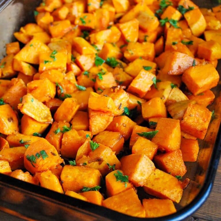 zoomed in photo of a pan of garlic and rosemary roasted sweet potatoes