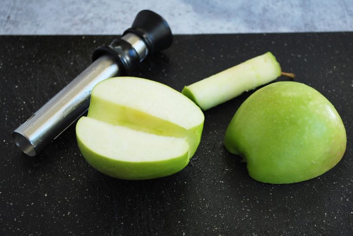 green apple cored on a cutting board