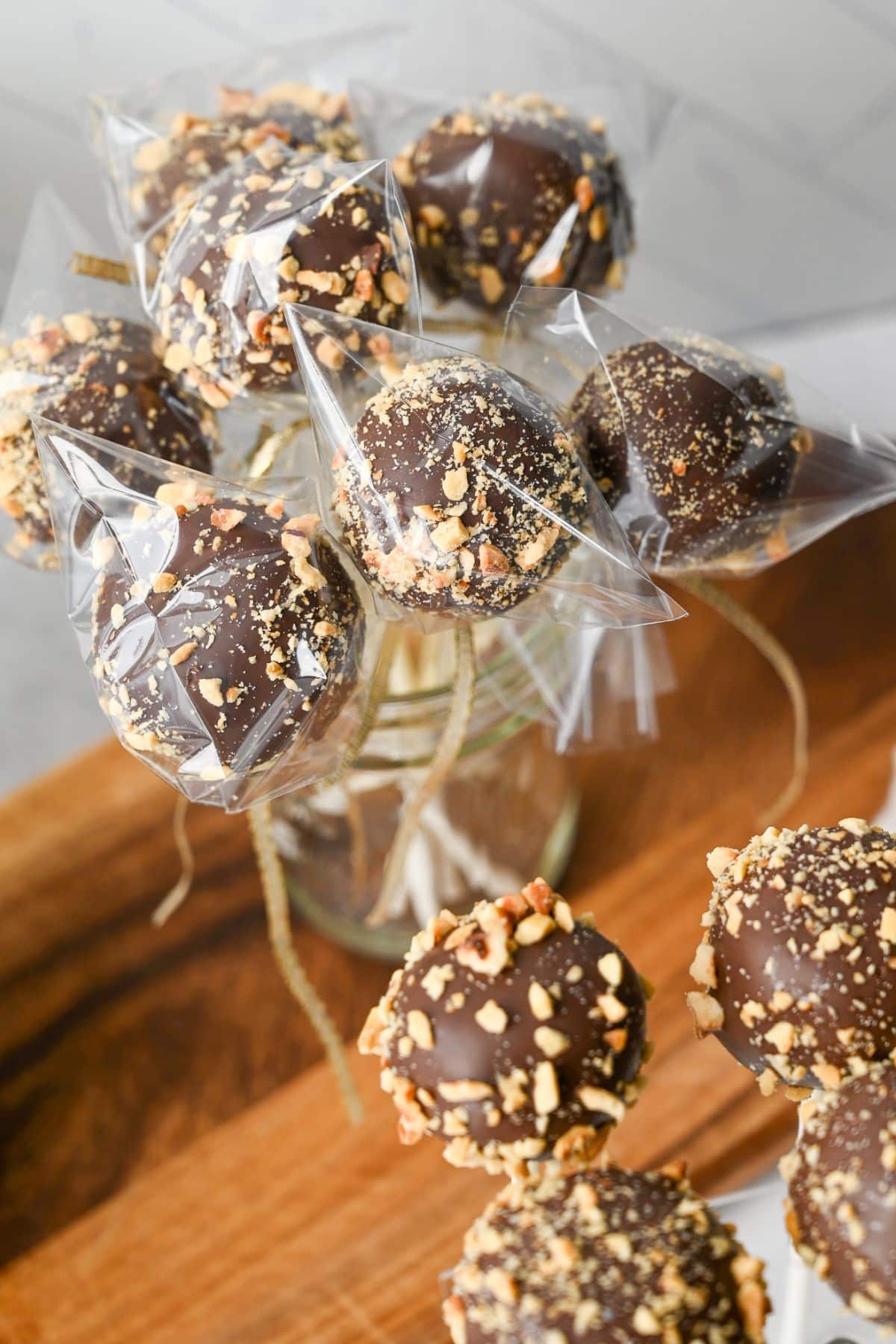 cake pops wrapped in bags with a gold ribbon