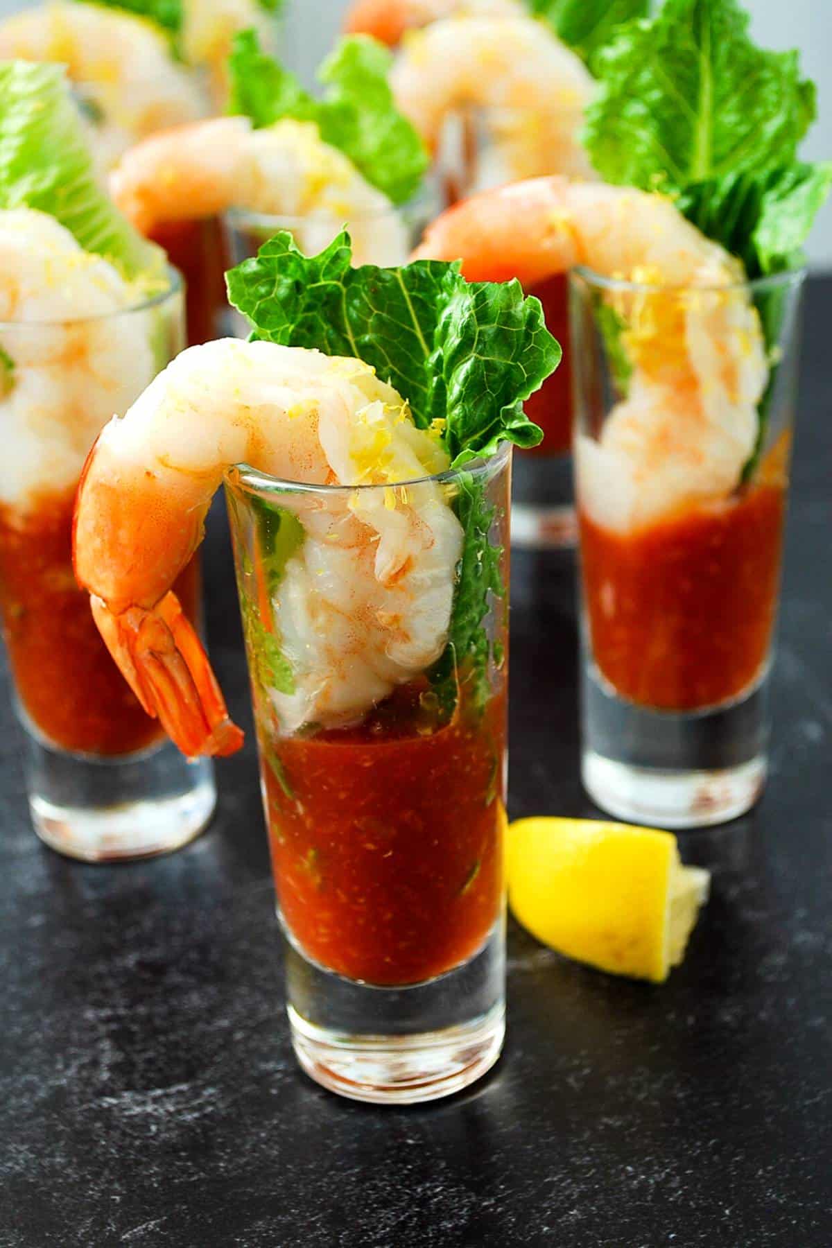 shrimp cocktail in mini parfait glasses with lemon wedges