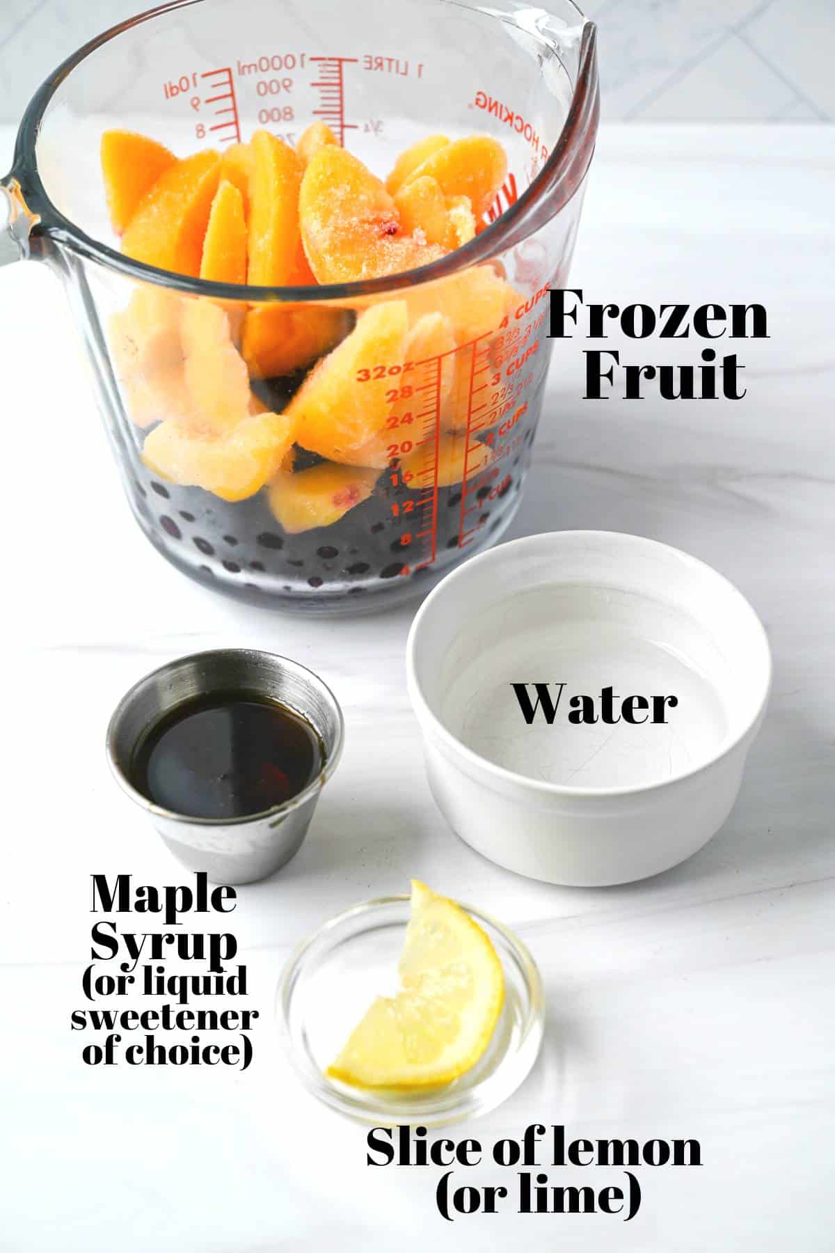 base ingredients for making blender sorbet: frozen fruit, water, maple syrup, and lemon slice