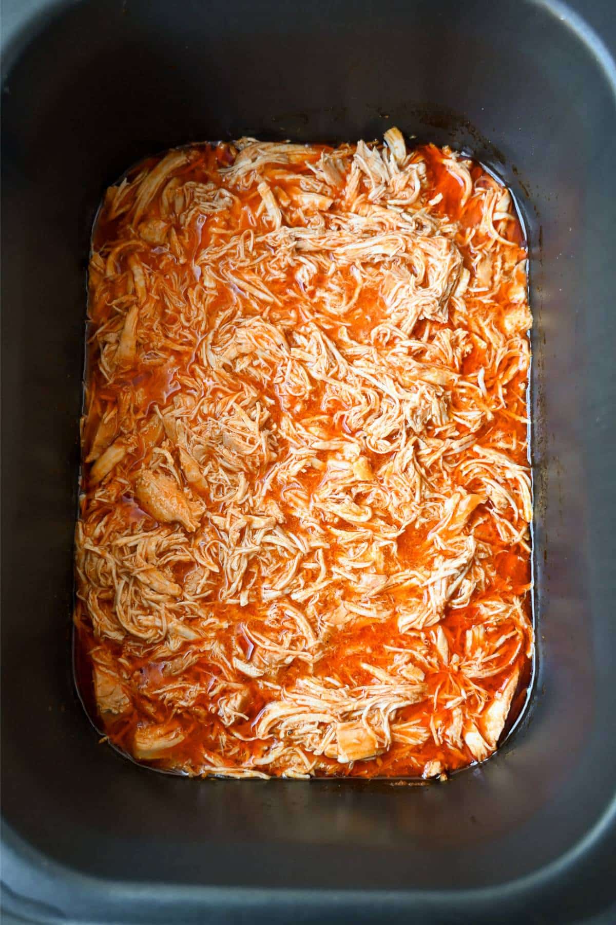 shredded buffalo chicken in a slow cooker