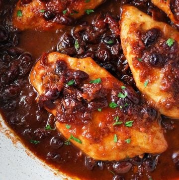 close up of sauteed chicken in a orange cranberry sauce