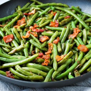 pan of sauteed green beans with almonds and bacon
