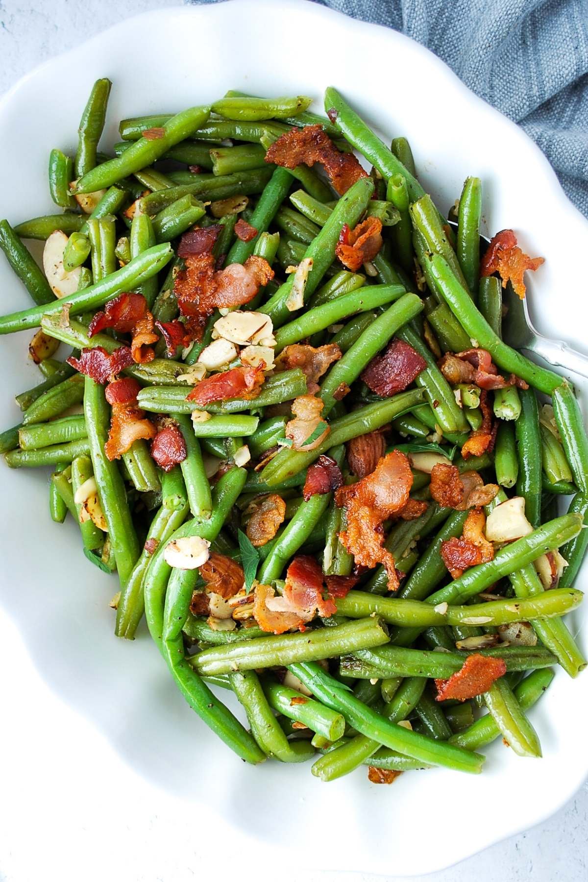 close up of green beans almondine with bacon