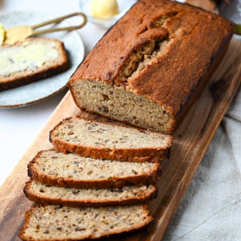 a loaf of banana bread made with oat flour sliced on a cutting board