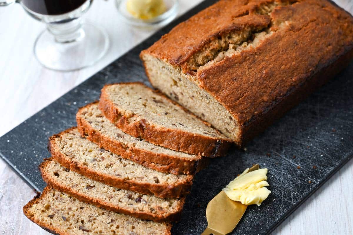 sliced banana bread with a knife and butter