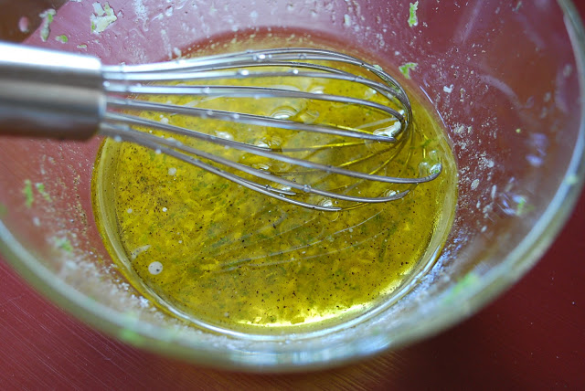 Close up of a marinade in a mixing bowl with a whisk