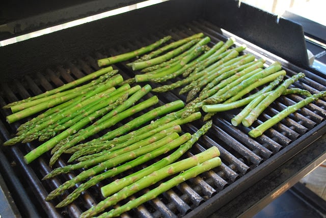 A bunch of green asparagus on a grill