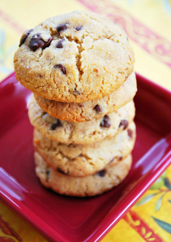 Stacked chocolate chip cookies on a red plate