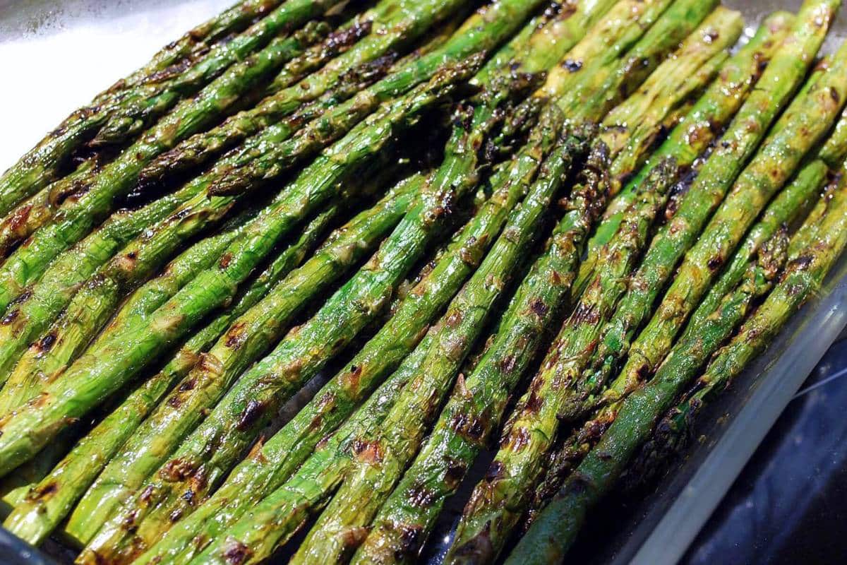 cooked grilled asparagus in a serving dish