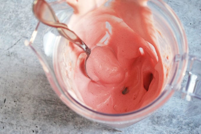 strawberry banana ice cream and a spoon in a bowl