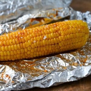 cooked corn unwrapped on top of foil