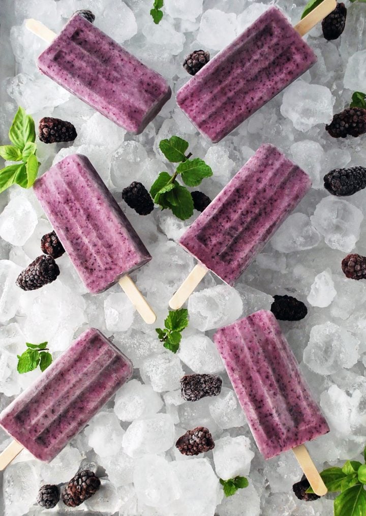 platter of ice and greek yogurt pops with berries and herbs