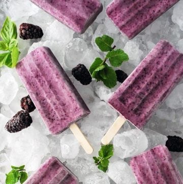 tray of popsicles with berries and mint