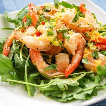 chilled marinated shrimp on a plate with greens