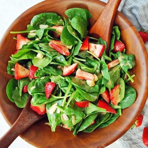close up of a bowl of strawberry spinach salad