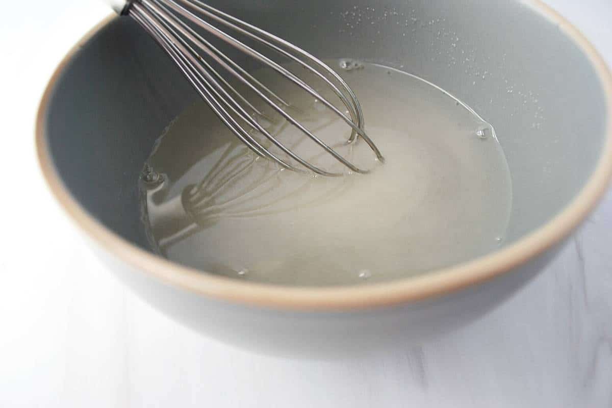 sugar and vinegar whisked in a gray bowl