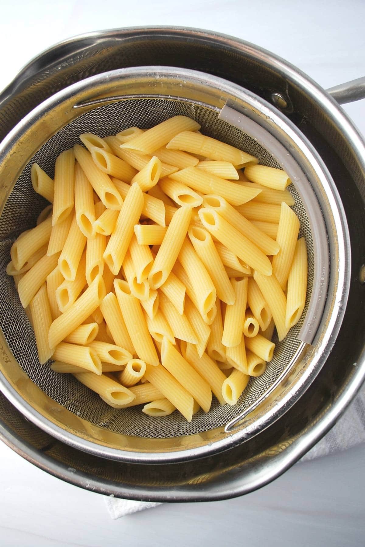 cooked and cooled pasta in a colander