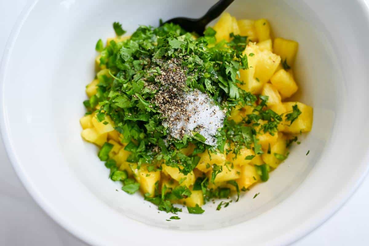 pineapple salsa ingredients in a white bowl