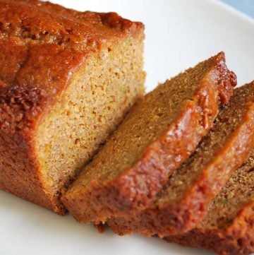close up of a loaf of zucchini bread sliced on a plate