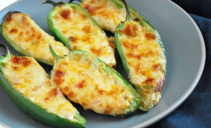 stuffed jalapeno peppers served on a grey plate with napkin