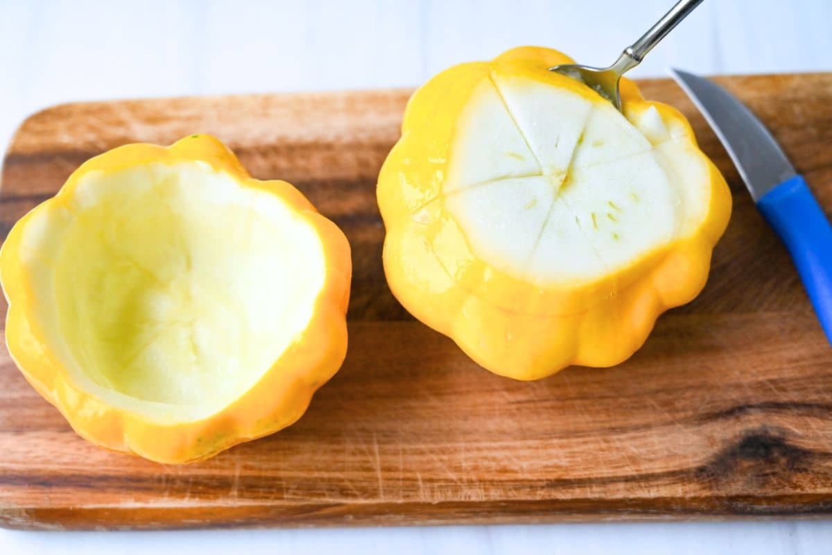 cutting a patty pan squash to scoop out the flesh