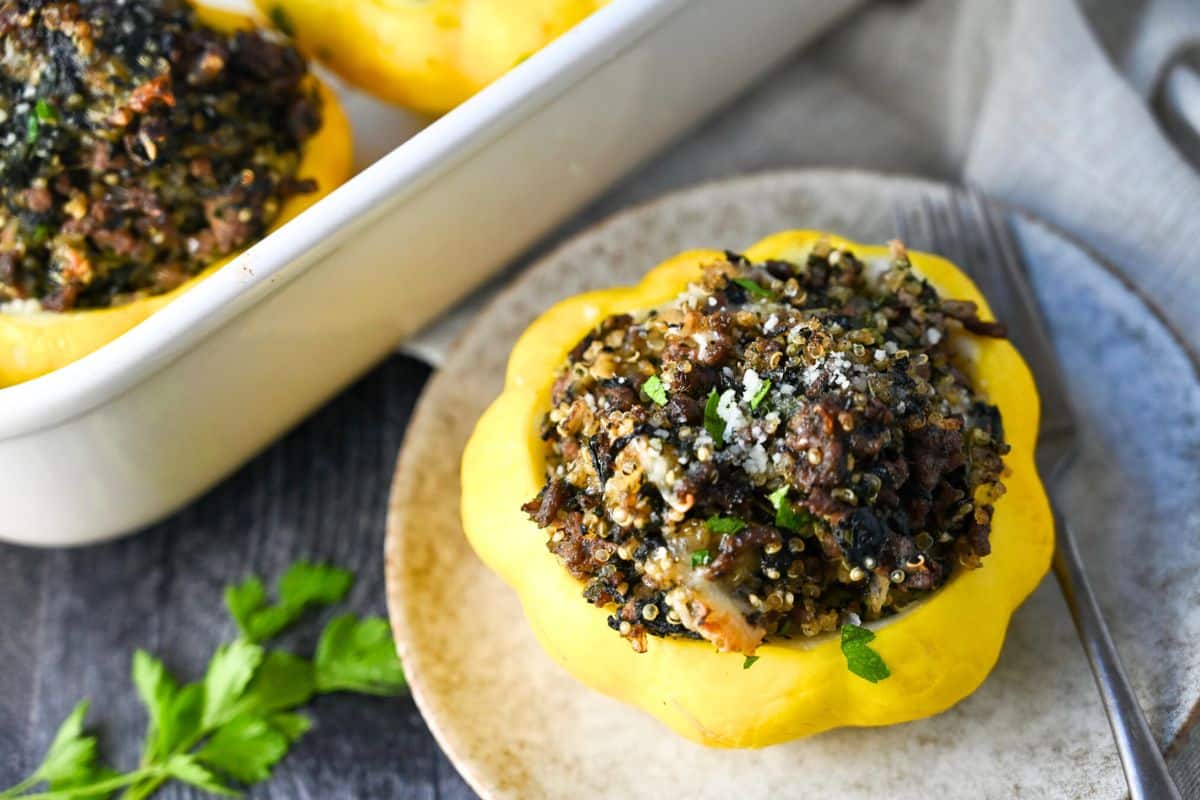 a stuffed patty pan with ground beef on a small plate with a fork and napkin