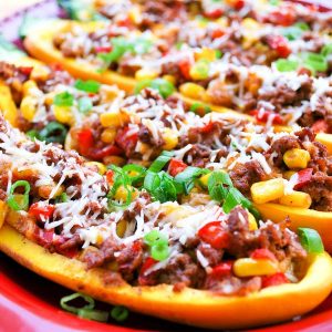 stuffed squash boats topped with cheese and chopped green onions