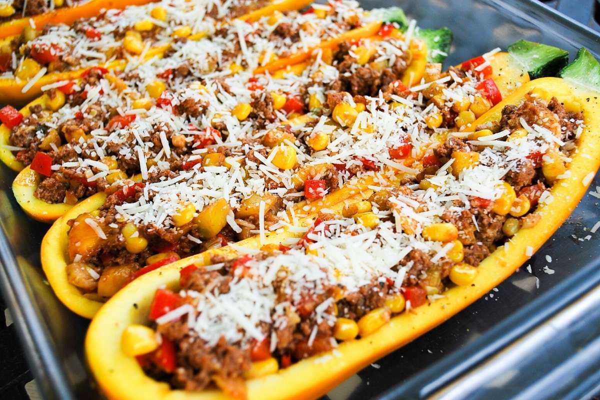ground beef stuffed yellow squash in a baking dish ready to cook