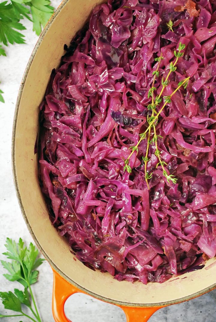 close up photo of pot of braised red cabbage with thyme sprigs on top