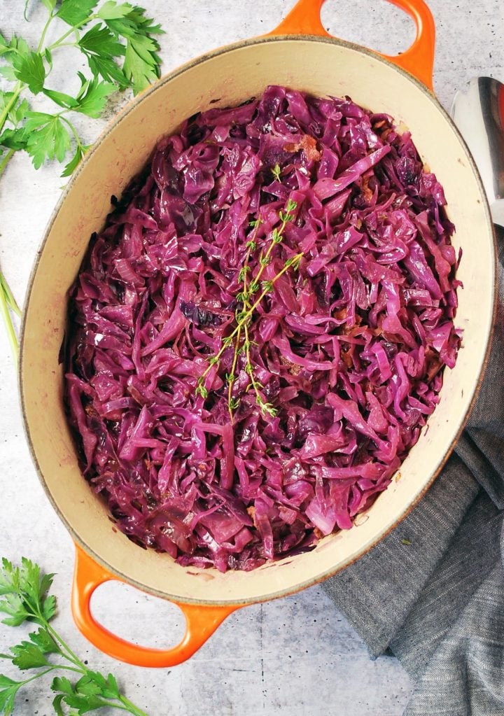 pot of braised red cabbage with herbs and napkin in the background