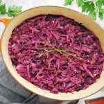 pot of braised red cabbage with fresh thyme on top