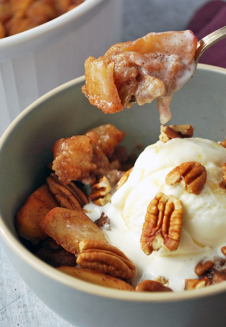 spoonful of baked apples with ice cream