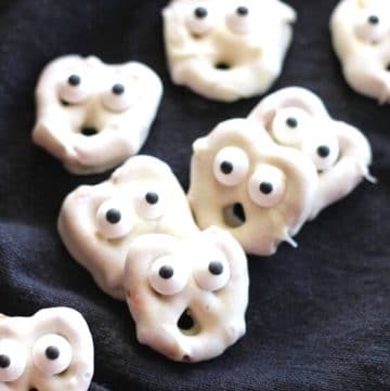 white chocolate covered pretzels with candy eyes to look like ghosts