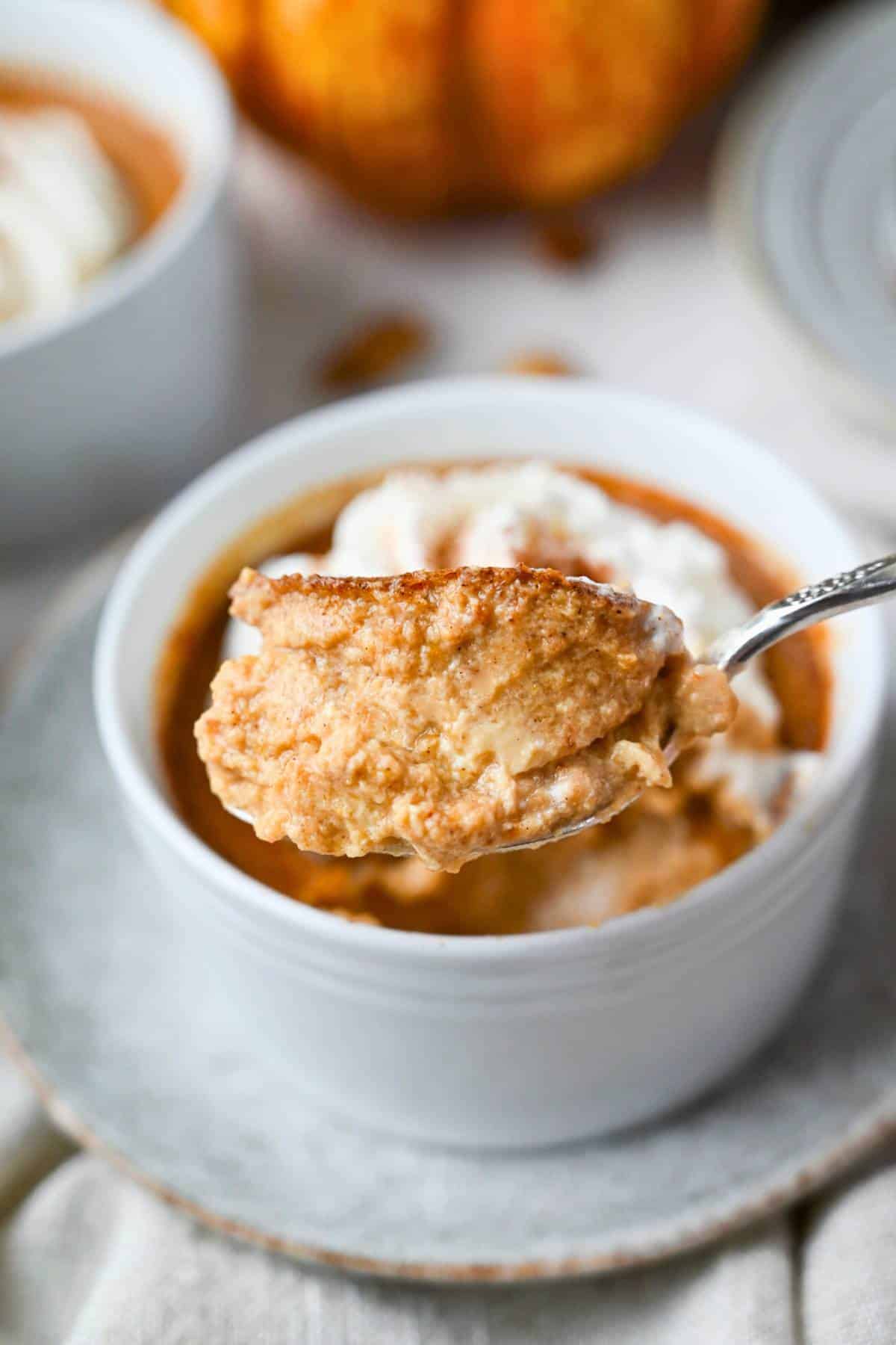 holding up a bite of pumpkin custard