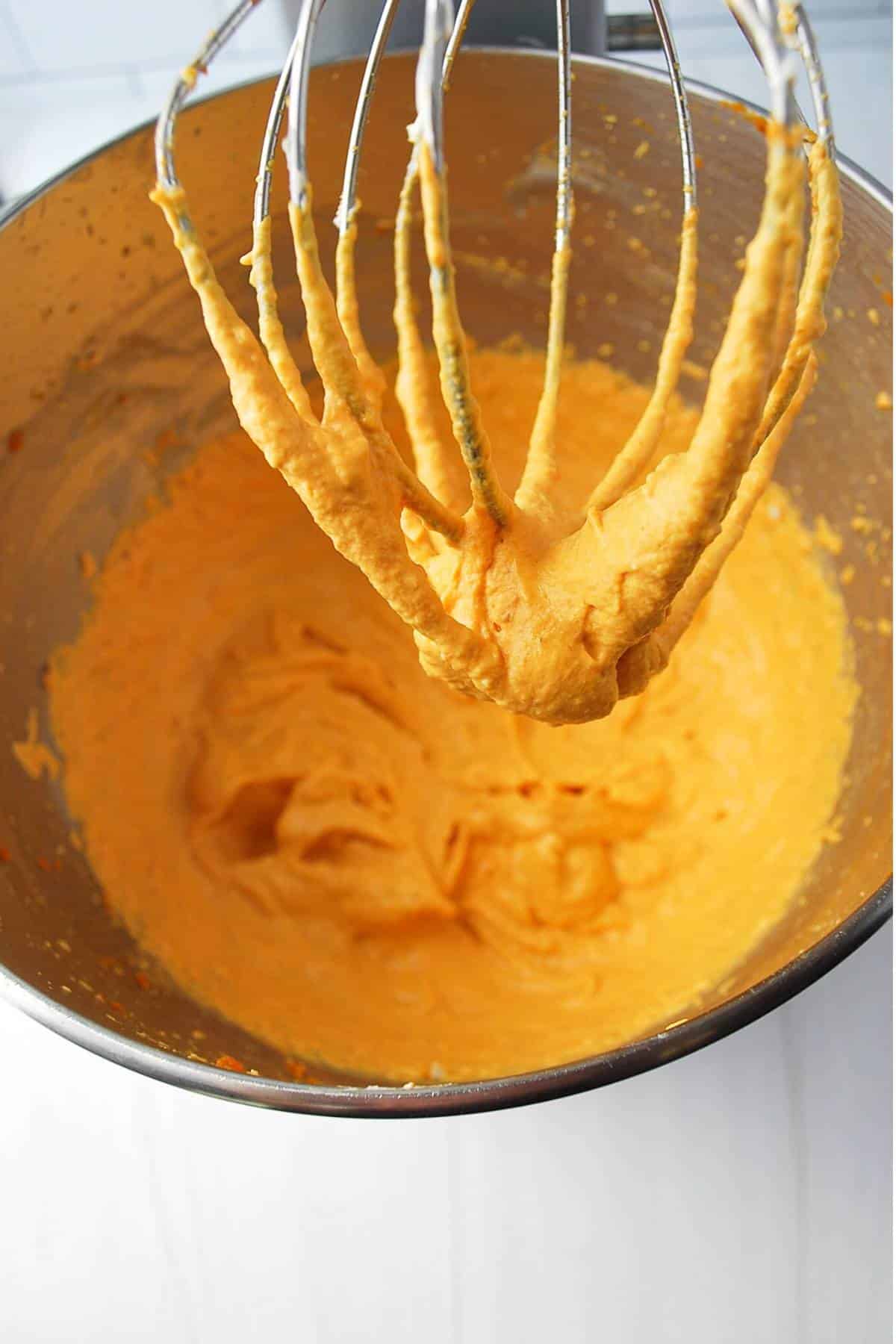 pumpkin dip mixed in a stand mixer with a whisk attachment