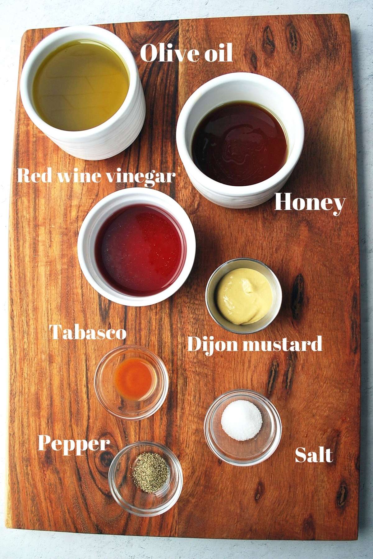 ingredients for honey mustard vinaigrette on a cutting board