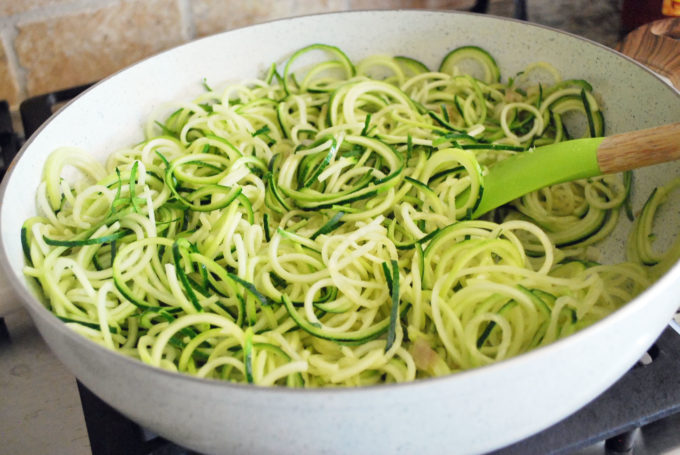 Zucchini noodles cooking on the stovetop