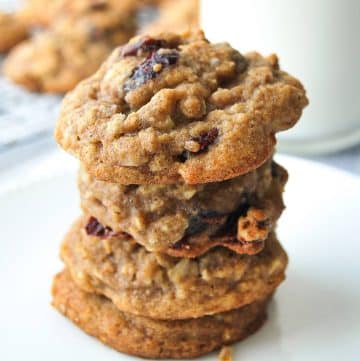 stack of gluten free oatmeal cranberry cookies with a glass of milk